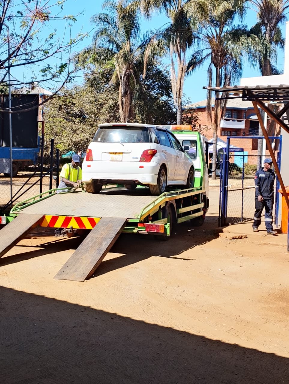 CarlTrans Logistics crew loading a recovered vehicle